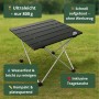 Schwarzer BigDean Klapptisch, faltbar, mit Aluminiumplatte und silbernen Beinen auf Gras. Ultraleicht, kompakt, schnell aufgebaut.