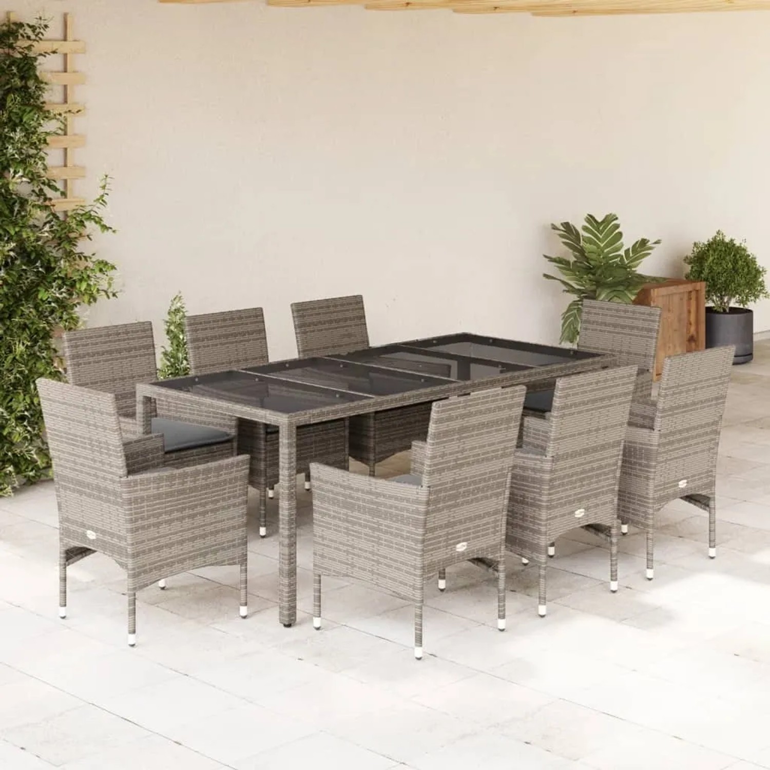 9-teilige Garten-Essgruppe aus grauem Poly Rattan mit Glasplatte und Kissen.