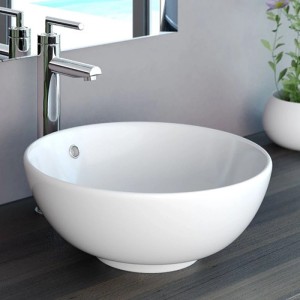 Weißes, rundes NEG Aufsatz-Waschbecken aus Keramik mit Überlauf auf dunkler Waschtischplatte. Ideal für moderne Bäder.