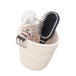 Weißer Wenko Aufbewahrungskorb Soria aus Baumwolle mit Bürste und Haarspange.