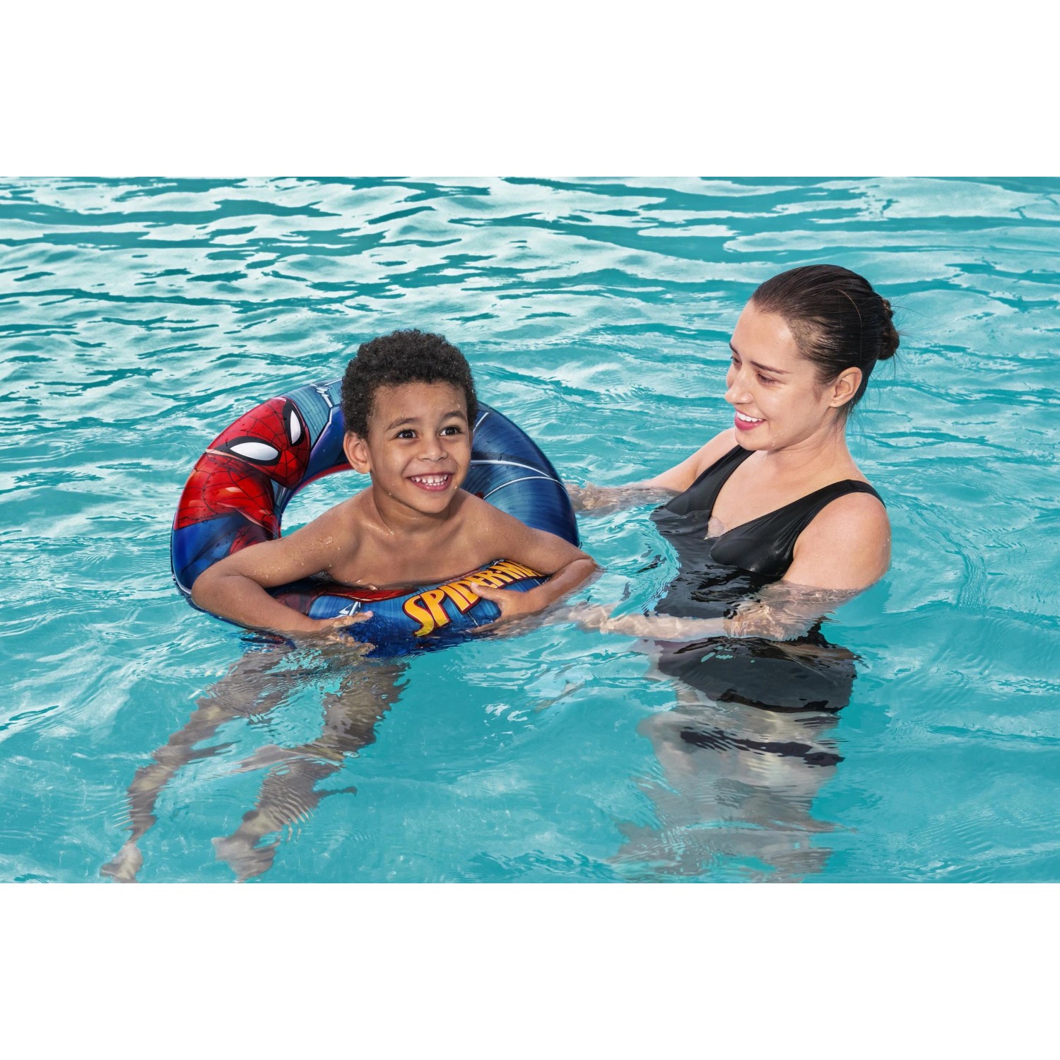 Kind mit Spider-Man Schwimmring (Ø 48 cm) im Pool mit Aufsichtsperson.