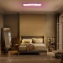 Ledvance Smart+ WiFi Panelleuchte Planon Plus mit farbigem Rücklicht in einem Schlafzimmer.