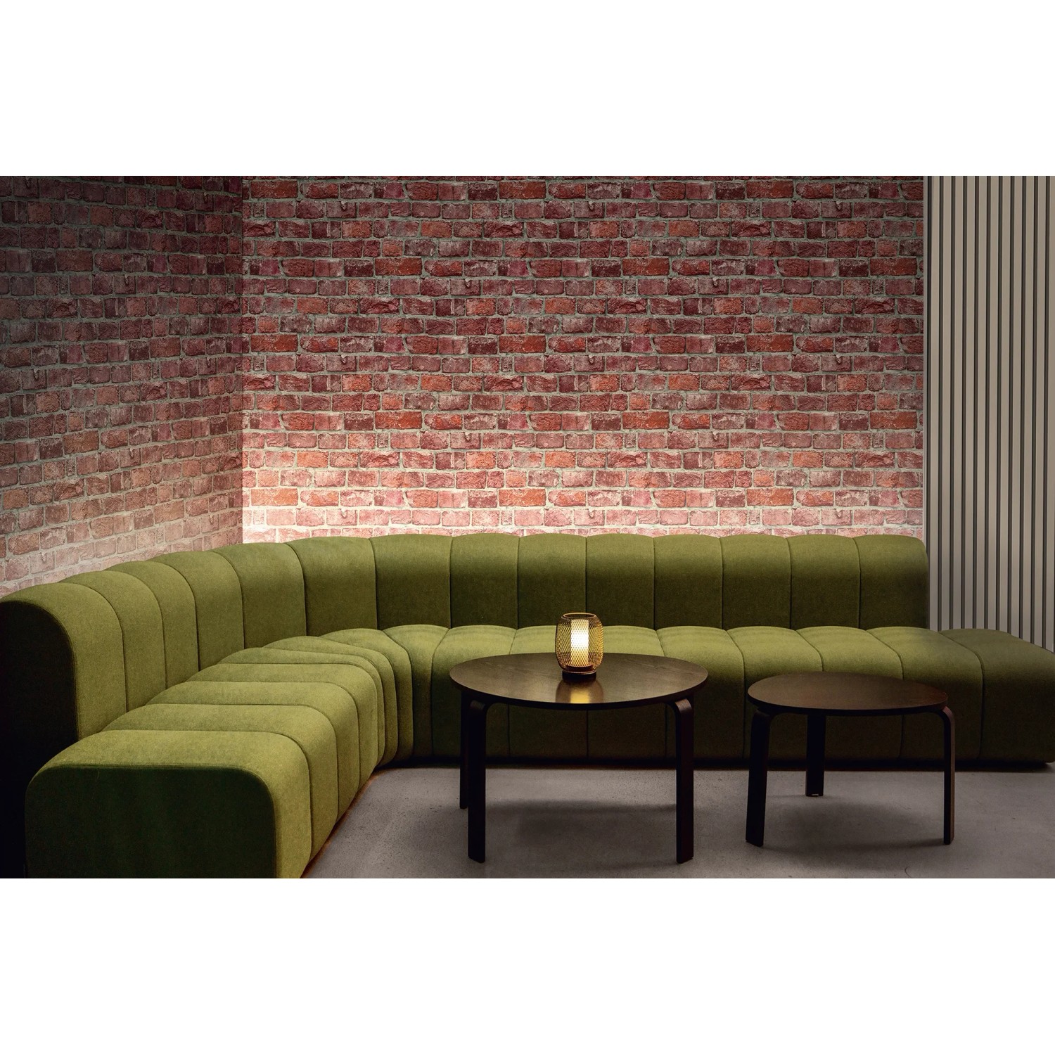 Wohnraum mit roter Marburg Vliestapete GZSZ in 3D Steinoptik hinter grüner Couch und Tisch.