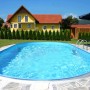 Ovaler Summer Fun Stahlwandpool Formentera, eingebaut im Garten mit Leiter und blauem Wasser.