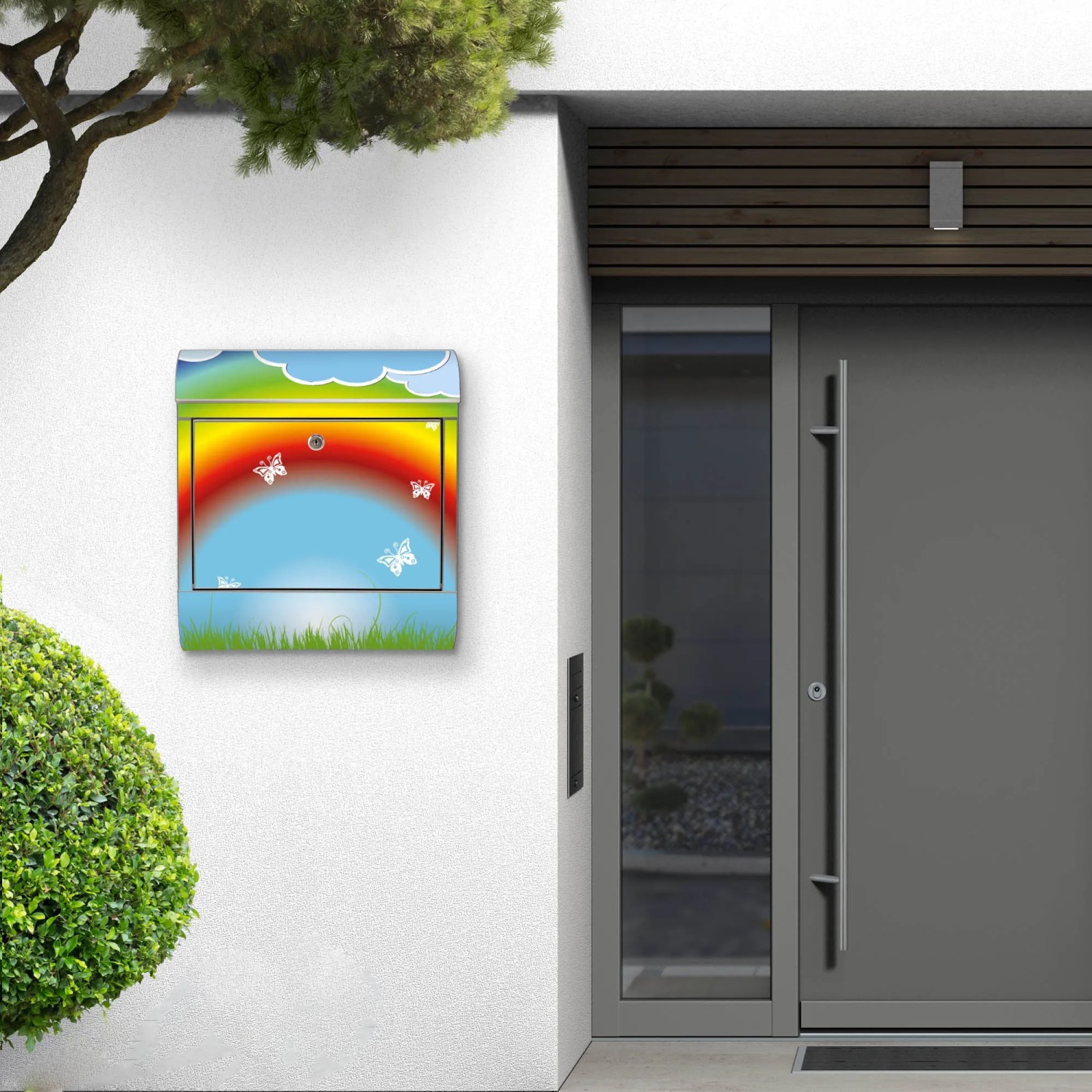 Edelstahl Briefkasten mit Regenbogen Motiv und Zeitungsfach an Hauswand.