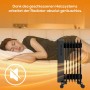 TroniTechnik Ölradiator schwarz mit 7 Rippen neben schlafender Person. Leiser Betrieb.