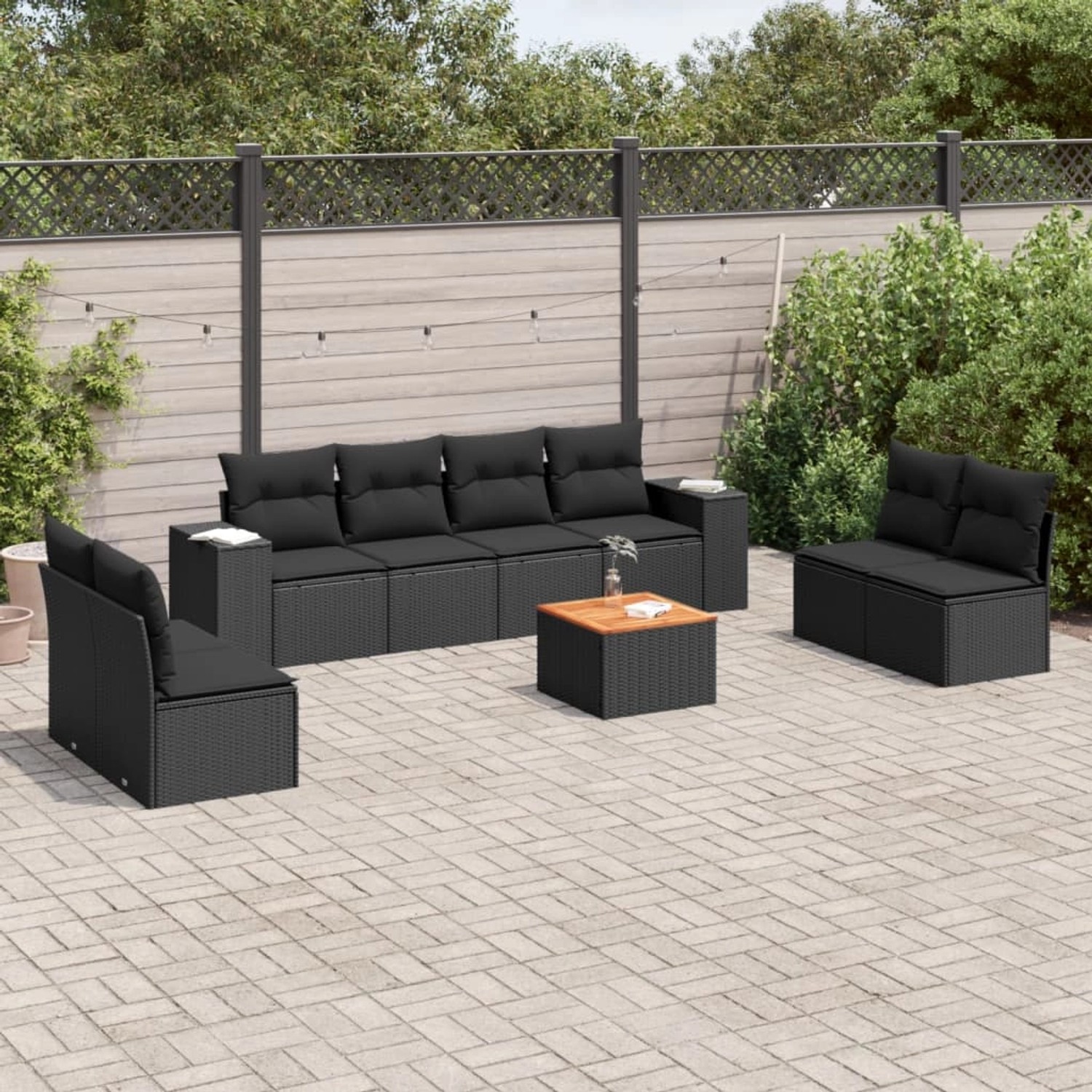 Schwarze 9-tlg. vidaXL Garten-Sofagarnitur aus Polyrattan mit Kissen im Garten.