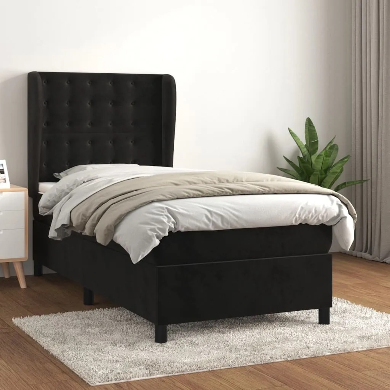 Schwarzes Boxspringbett (90x200 cm) mit Samtbezug, inklusive Matratze und Kopfteil.