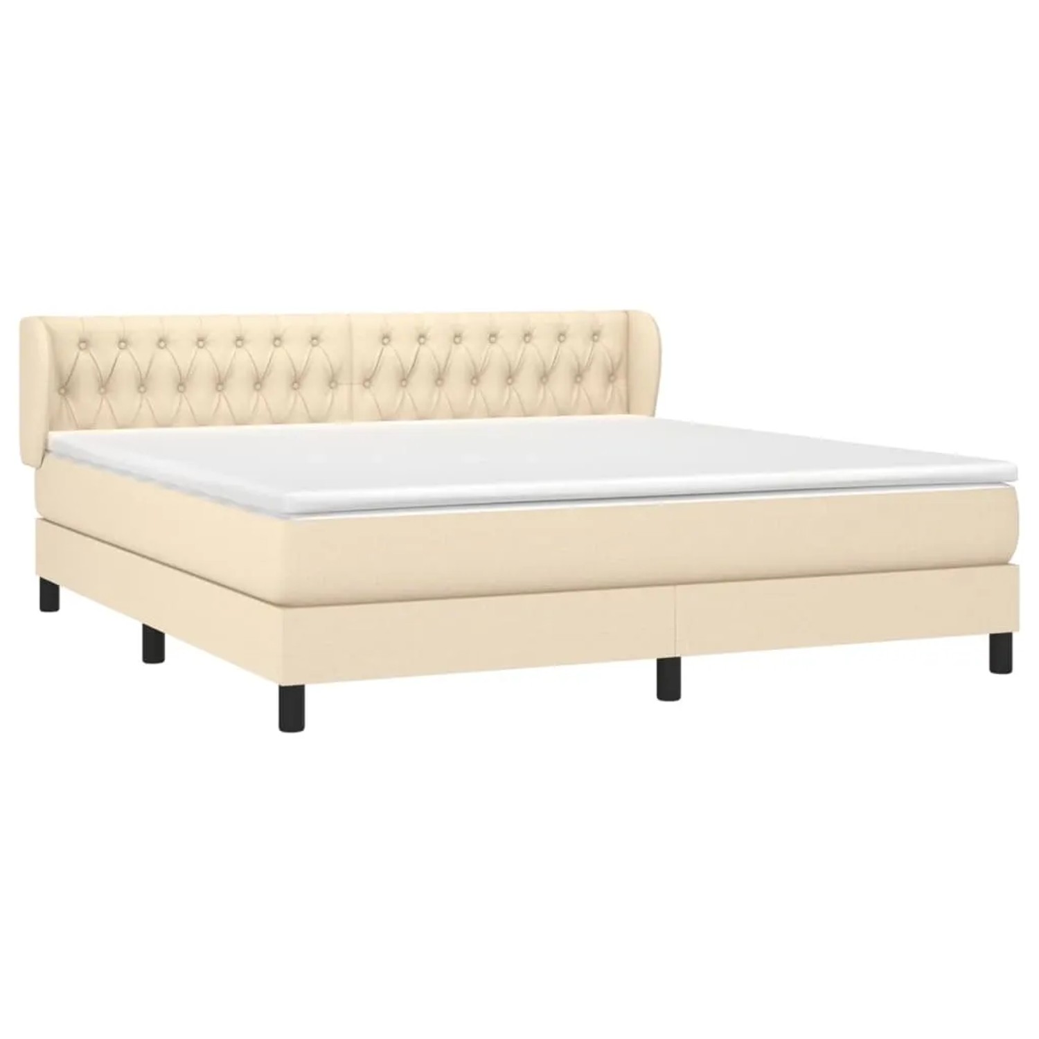 Cremefarbenes Boxspringbett 180x200 cm mit Stoffbezug und gestepptem Kopfteil.