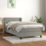 Helles Boxspringbett 90x190 cm mit Matratze, hellgrauer Samtbezug, inklusive Kopfteil und Topper.