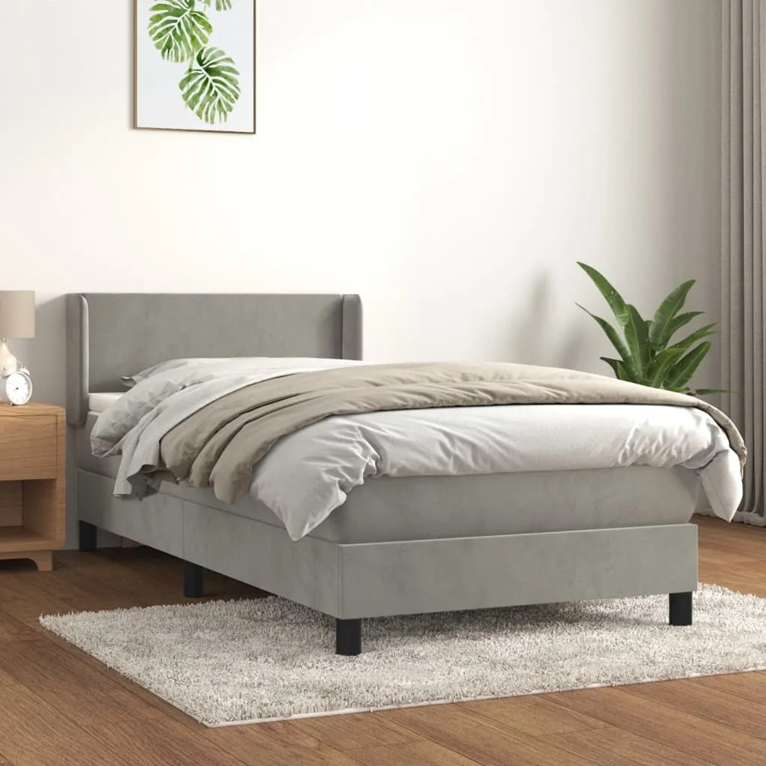 Helles Boxspringbett 90x190 cm mit Matratze, hellgrauer Samtbezug, inklusive Kopfteil und Topper.