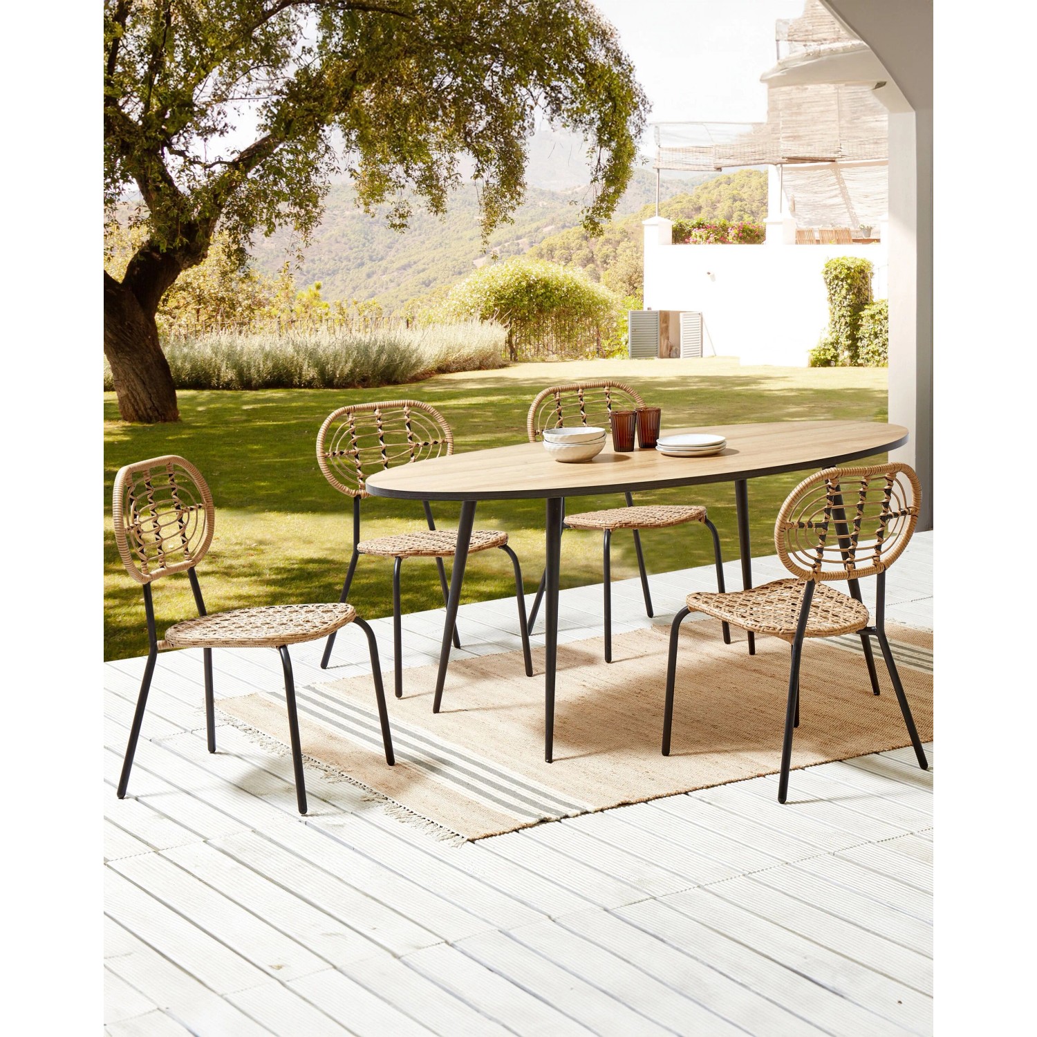 Beliani Gartenstühle, 4er Set, naturfarbenes Rattan mit schwarzen Metallbeinen.