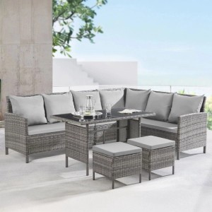 Graues Svita Madison Rattan-Lounge Gartenmöbel-Set mit Ecksofa, Tisch und Hockern auf Terrasse.