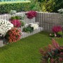 Bepflanzte graue Wellino Pflanzsteine als stufenförmige Hangbefestigung im Garten.