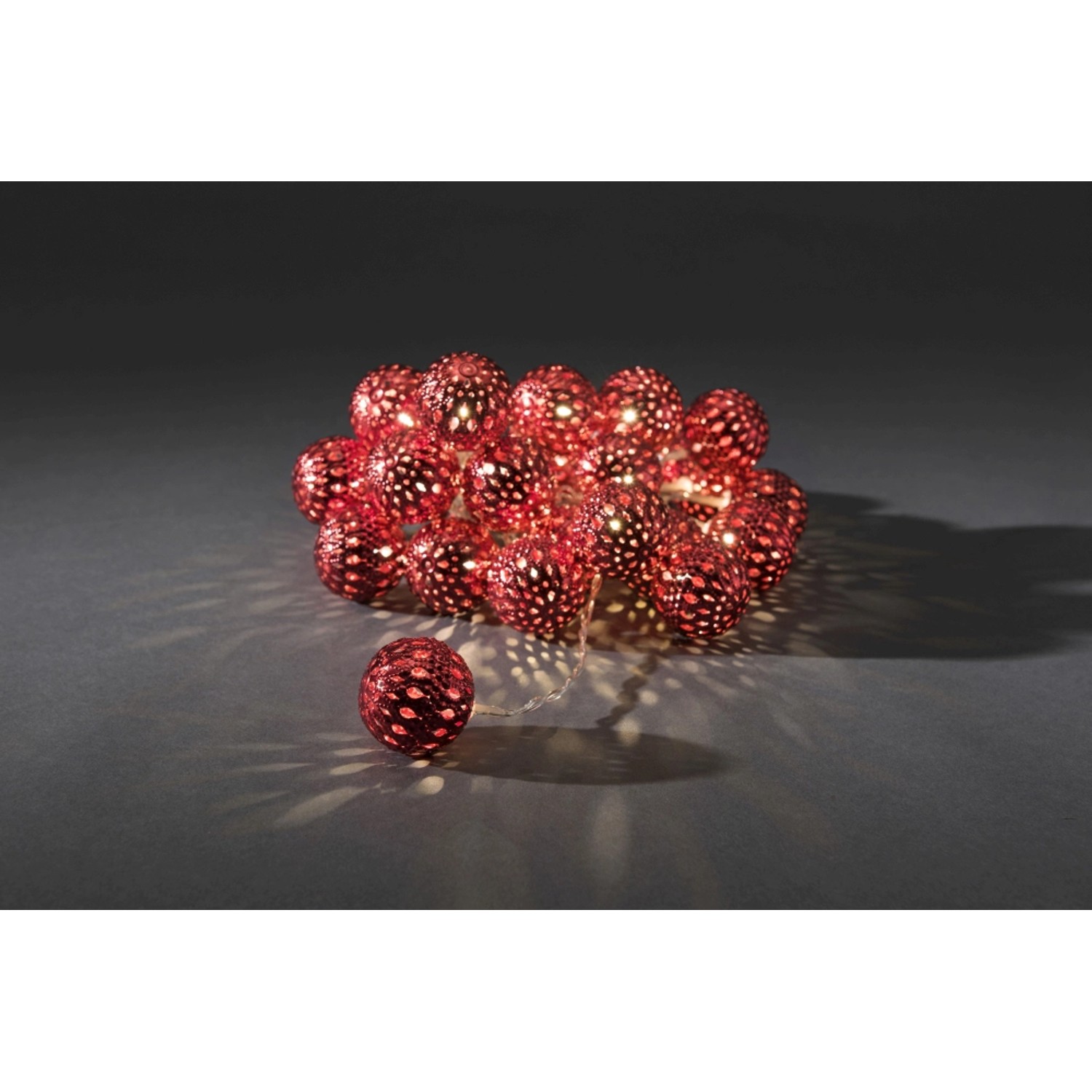 Konstsmide LED Dekokette mit roten Metallbällen und warmweißem Licht für Innenräume.