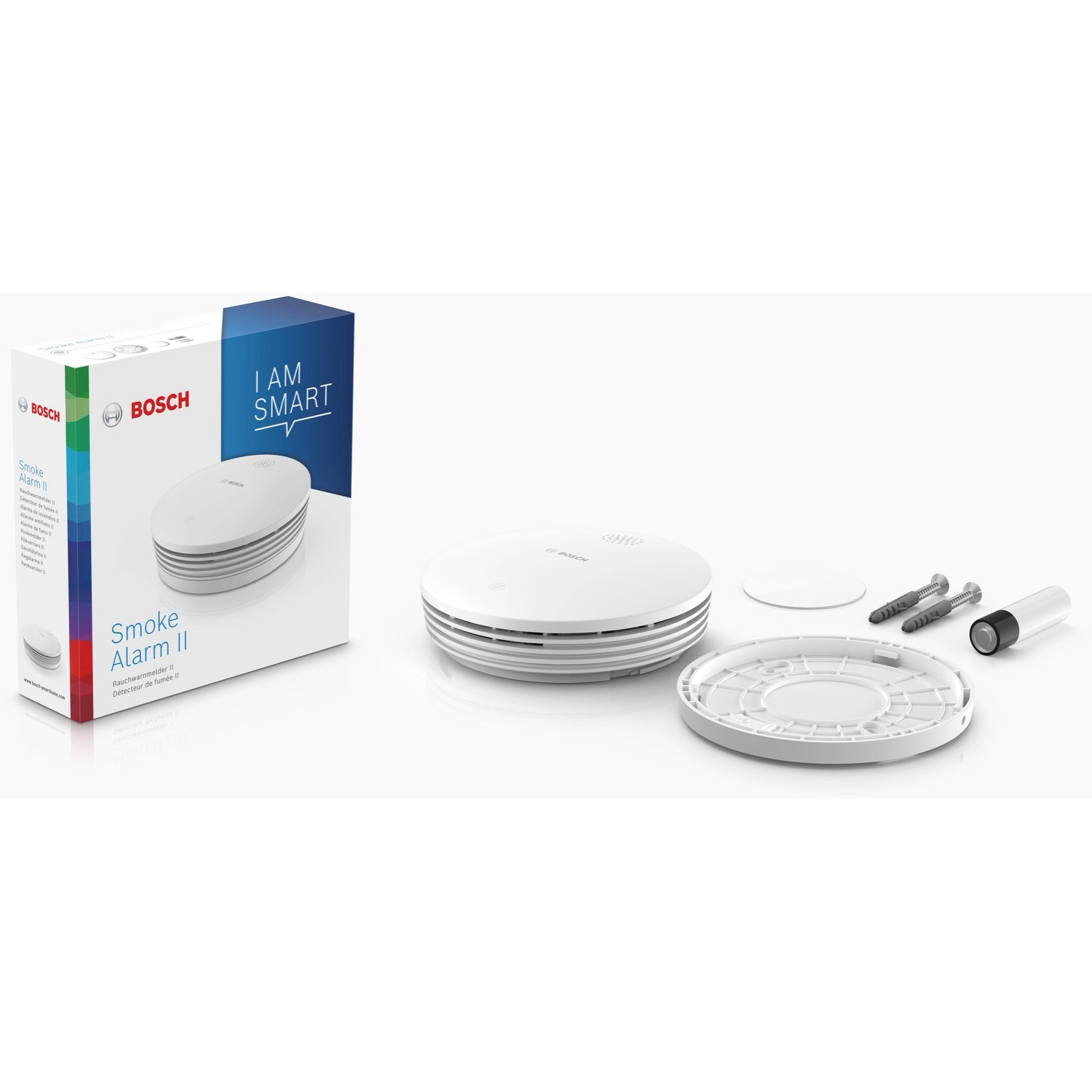 Bosch Smart Home Rauchwarnmelder II mit Verpackung und Zubehör wie Schrauben und Batterie.