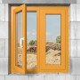 Gelber Fensterrahmen in Mauerwerk eingebaut, ein Fenster geöffnet.