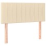 Cremefarbenes Boxspringbett 90x200 cm mit Stoffbezug und Kopfteil.