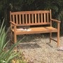 Acamp Gartenbank Woody 2-Sitzer aus Teakholz (FSC®) im Garten, mit Buch und Getränk dekoriert.