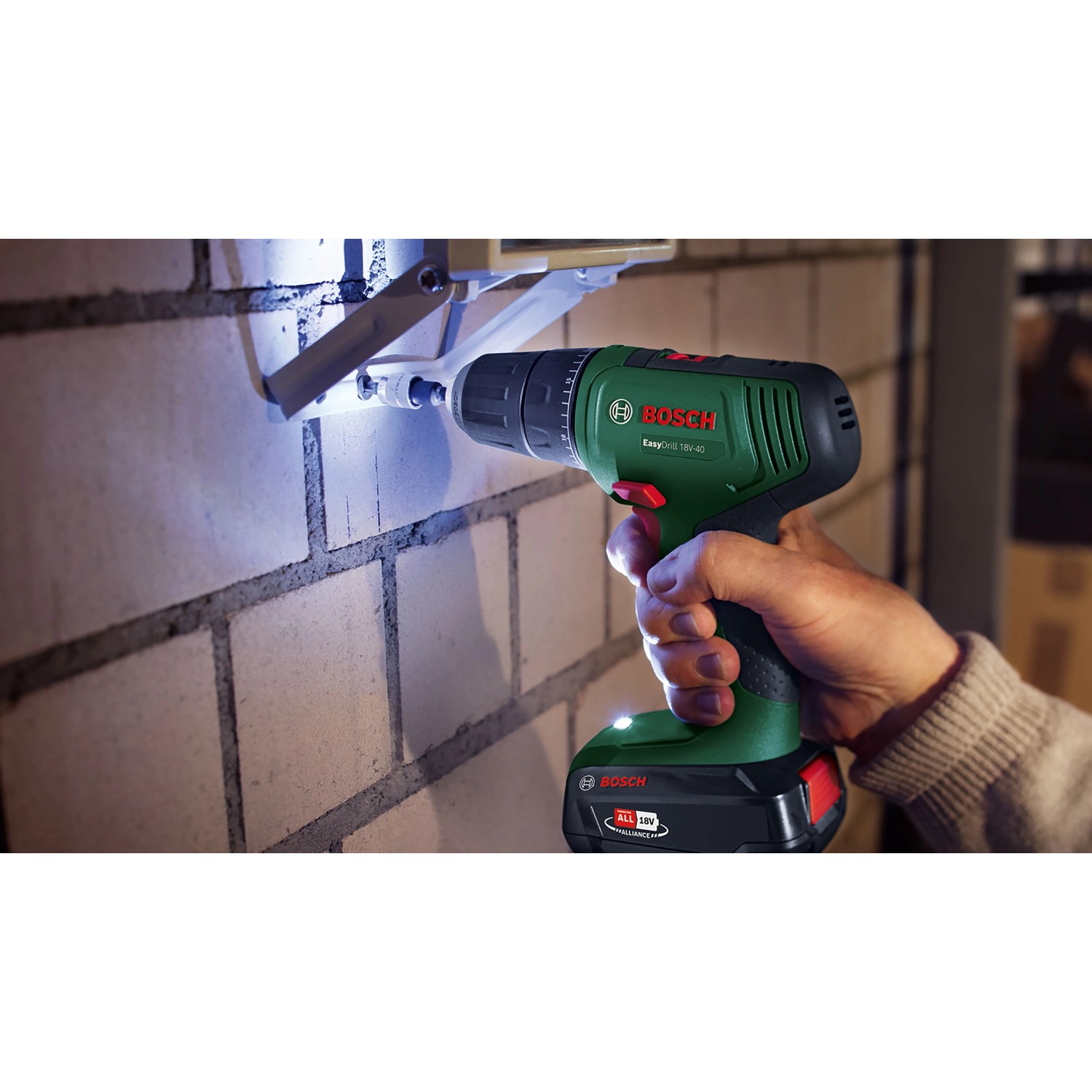 Bosch Akkubohrschrauber EasyDrill 18V-40, grün, bohrt mit LED-Licht in Ziegelwand. Vielseitiger Akkuschrauber.