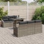 7-teiliges Garten-Sofa-Set aus grauem Poly Rattan mit Tisch und grauen Kissen.