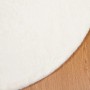Runder cremefarbener Kunstfell Teppich aus Polyester, Ø 200 cm, mit weicher, flauschiger Textur auf Holzboden.