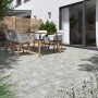 Verlegte Terrassenplatten Naturstein Sino Grau 60x30 cm im Außenbereich mit Sitzgruppe.