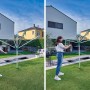 Leifheit Wäschespinne Linomatic V 40m im Garten mit Frau beim Öffnen des Wäscheständers.
