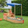 Juskys Sandkasten Käpt n Pit Piratenschiff aus Holz mit blauem Sonnensegel im Garten.