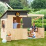Soulet Kinderspielhaus Santa Barbara mit Anbau und spielenden Kindern im Garten.