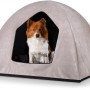 Beige Knuffelwuff Hundehöhle Yucatan Velours (M-L, 90x70x70cm) mit Hund im Eingang.