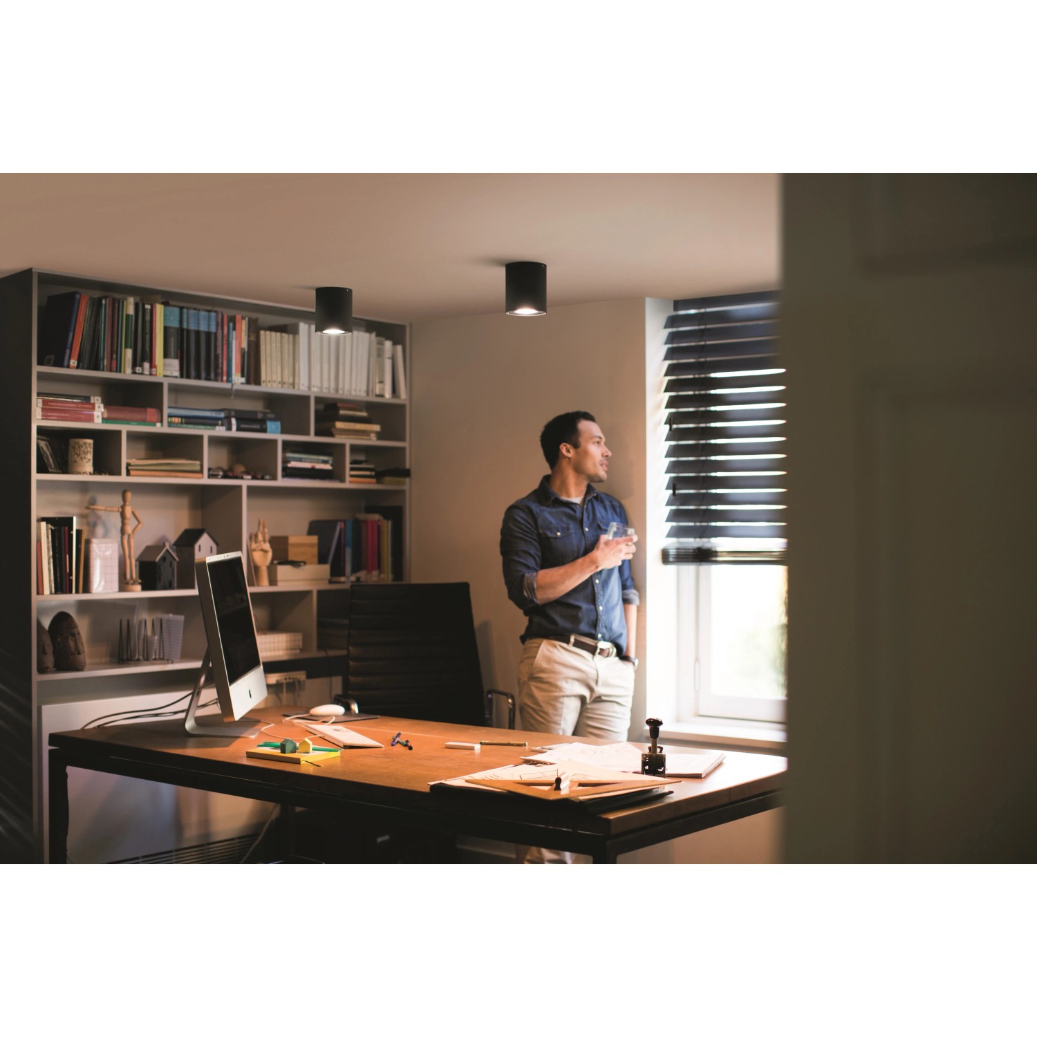 Schwarzer Philips Hue Pillar LED-Aufbauspot im modernen Arbeitszimmer.