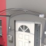 Modernes Bogenvordach in Edelstahloptik mit Acrylglas und Regenrinne am Hauseingang.