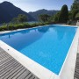 Styropor Pool-Set Classic Top: Rechteckiger Pool mit blauem Wasser und Holzdeck vor Bergkulisse.