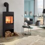 Schwarzer Haas+Sohn Kaminofen mit Holzfach und brennendem Feuer im Wohnraum.