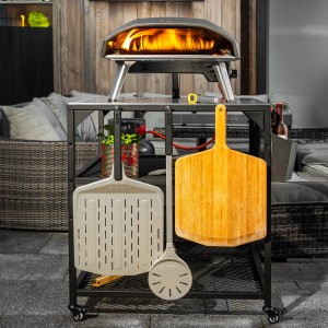 Ooni Pizzawendeheber und Grillutensilien an einem Pizzaofenwagen.