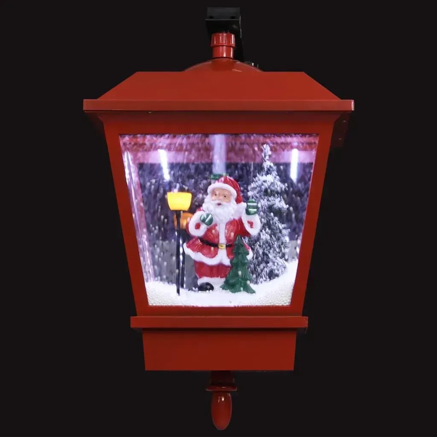 Rote Weihnachts-Wandleuchte mit LED-Licht und Schneefall. Innen: Weihnachtsmann, Baum, Laterne. Festliche Weihnachtsdekoration.