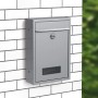 Basi Briefkasten BK 100 aus Edelstahl mit Schloss und Sichtfenster an weißer Wand.