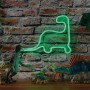 Paulmann LED Strip Neon Colorflex Grün, Dinosaurier-Form, mit Deko-Dinos vor einer Backsteinwand.