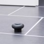 Schwarzer Wagner Bodentürstopper EH5201 aus Gummi auf grauem Fliesenboden.