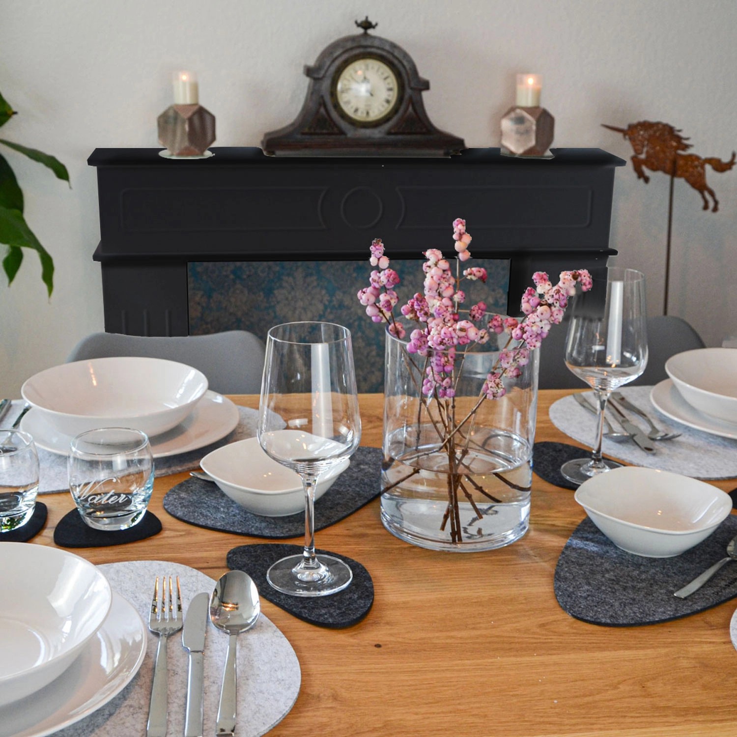 Gedeckter Tisch mit schwarzer DuneDesign Kaminkonsole im Hintergrund. Wohnzimmerschrank mit Stauraum.