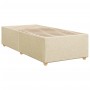 Cremefarbenes Boxspringbett 80x200 cm mit Lattenrost und Füßen.