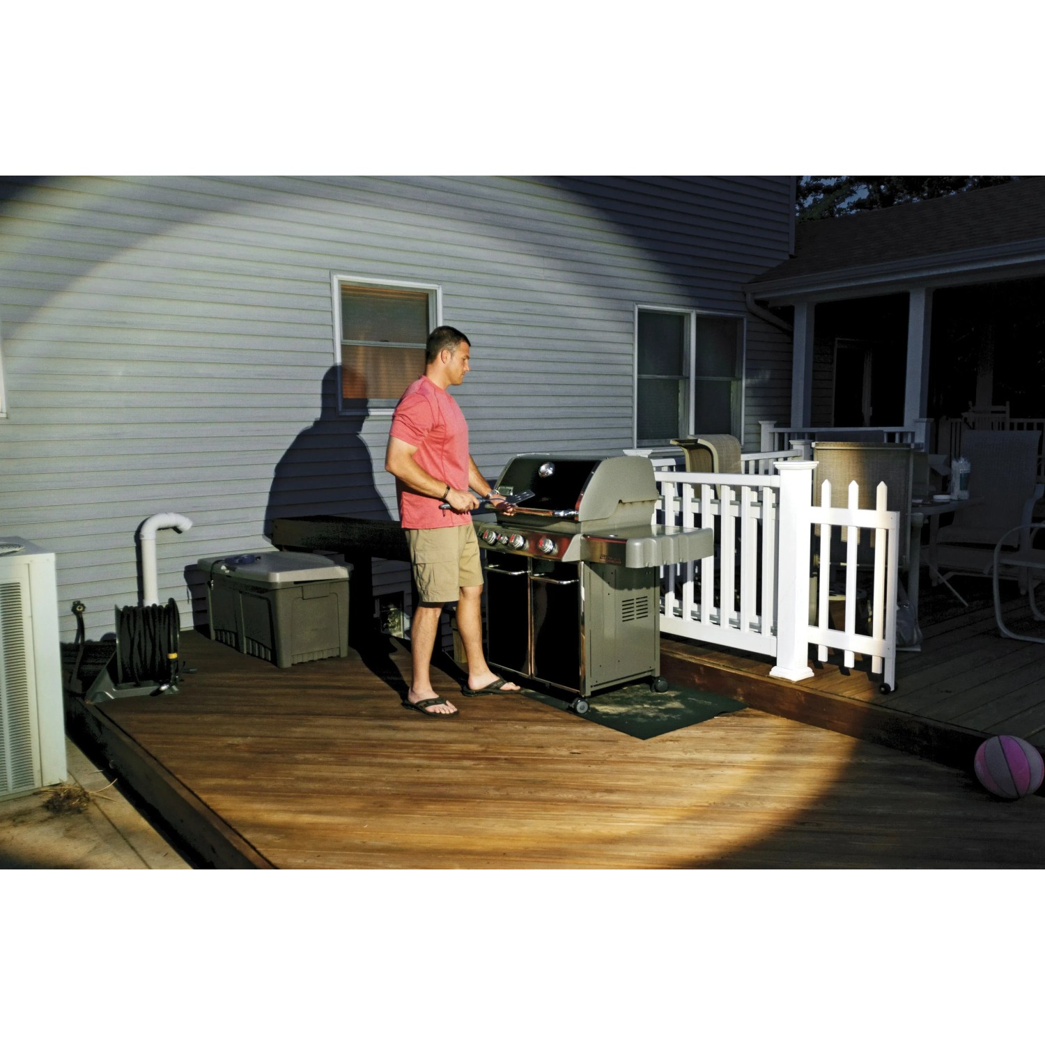 Mann grillt im Licht von Mr. Beams LED-Außenstrahlern mit Bewegungsmelder (2er-Pack).