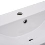 Weißes Keramik Einbauwaschbecken mit glänzender Oberfläche, Hahnloch, Überlauf und Abfluss. Modernes Design für Ihr Bad.