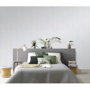 Helles Schlafzimmer mit Erismann Vliestapete Charisma Uni Hellgrau FSC® an der Wand.
