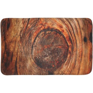 Sanilo Badteppich 70x110 cm mit rustikalem Baumscheiben-Motiv für ein natürliches Badezimmer-Ambiente.