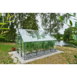 Halls Gewächshaus Universal 128 aus Alu mit 9,9 m² und Fundamentrahmen im Garten.