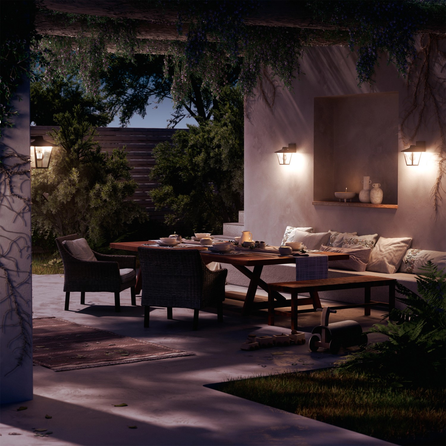 Philips Kinno LED-Außenwandleuchte in Schwarz an einer Terrasse mit Esstisch.