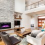 El Fuego Elektrokamin Bern 130 mit LED-Ambientelicht an Steinwand im Wohnzimmer.