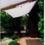 Floracord Pergola Bausatz mit weißem Sonnensegel (420 cm) am Haus montiert.